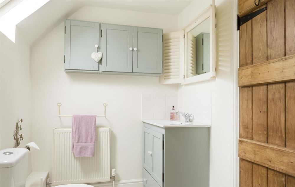 Family bathroom with bath and overhead shower at Hope Cottage, Quenington
