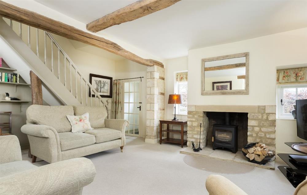 Sitting room with wood burner stove at Hope Cottage, Quenington