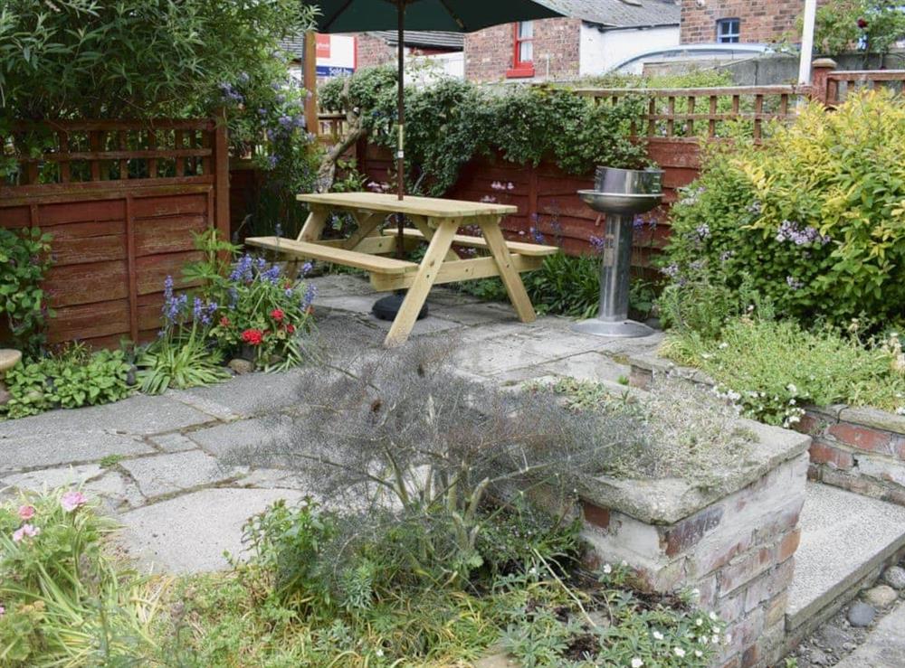 Enclosed garden with sitting-out area, garden furniture and BBQ at Hope Cottage in Whitby, Yorkshire, North Yorkshire