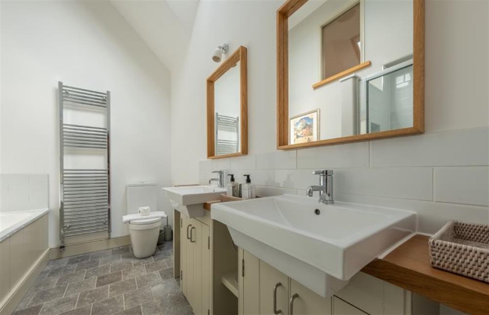 Bedroom one’s en-suite with twin wash basins at Horse Yard Barn, Warham