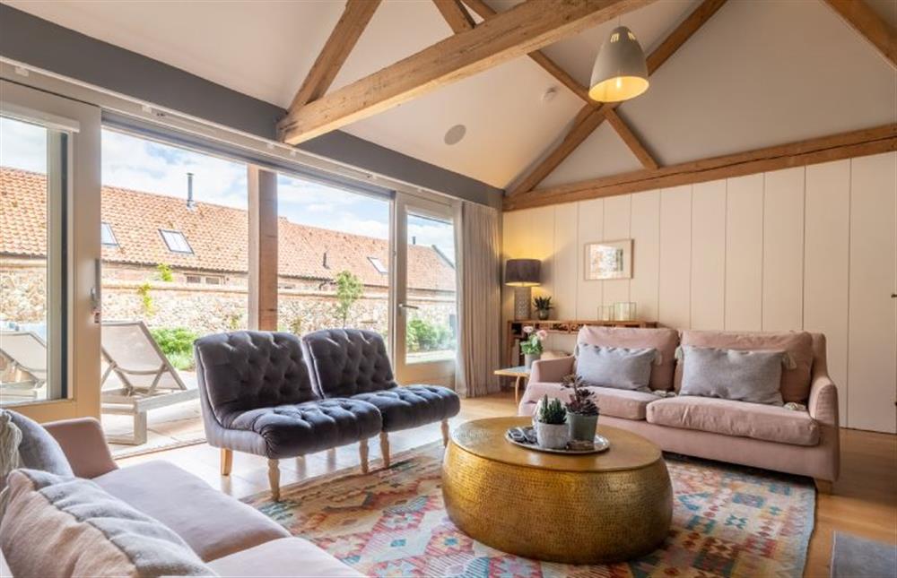 Comfortable seating and natural light fills the sitting room at Horse Yard Barn, Warham