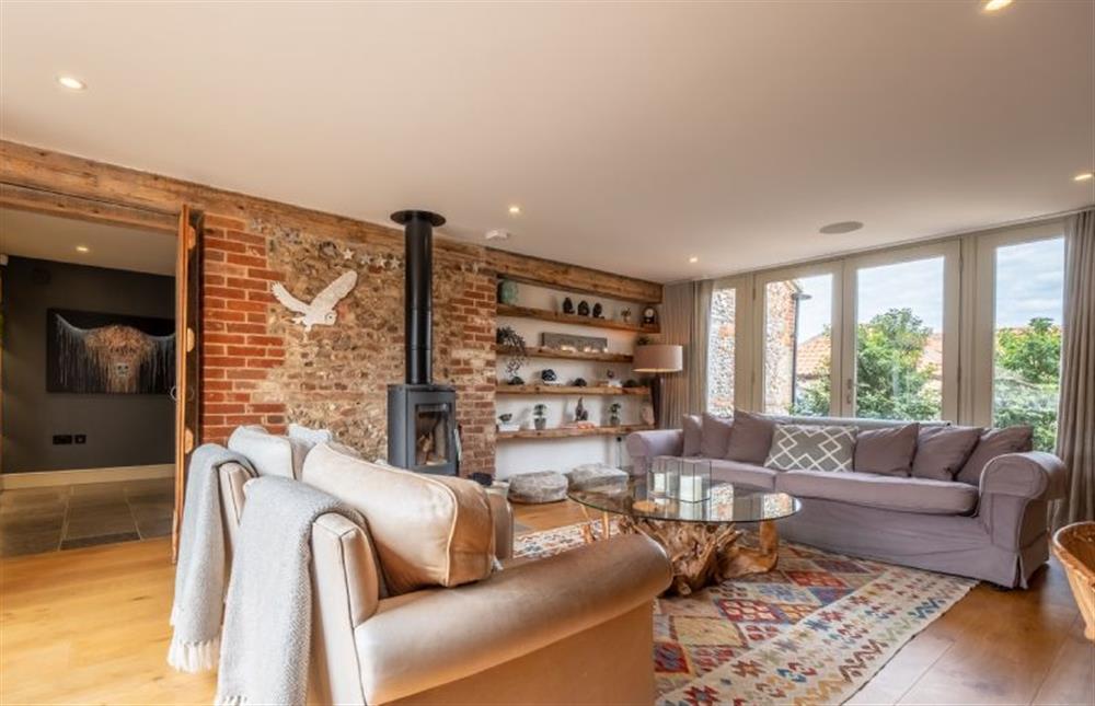 Wood burning stove in the family room provides comfort and warmth on cooler evenings at Horse Yard Barn, Warham