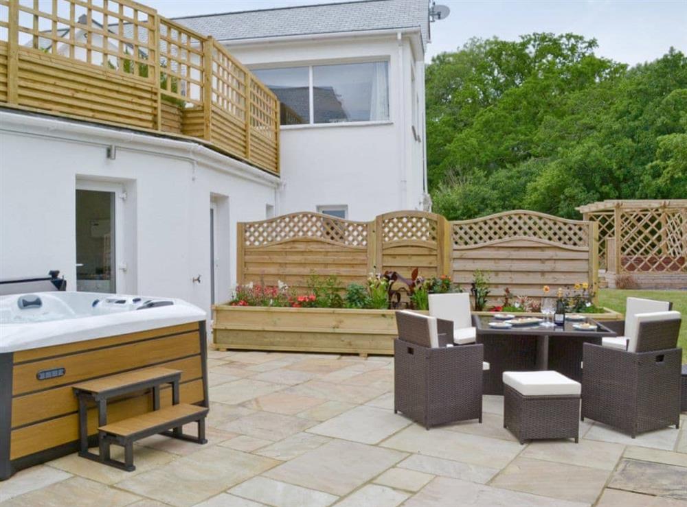 Patio with hot tub and outdoor furniture at Sundance, 