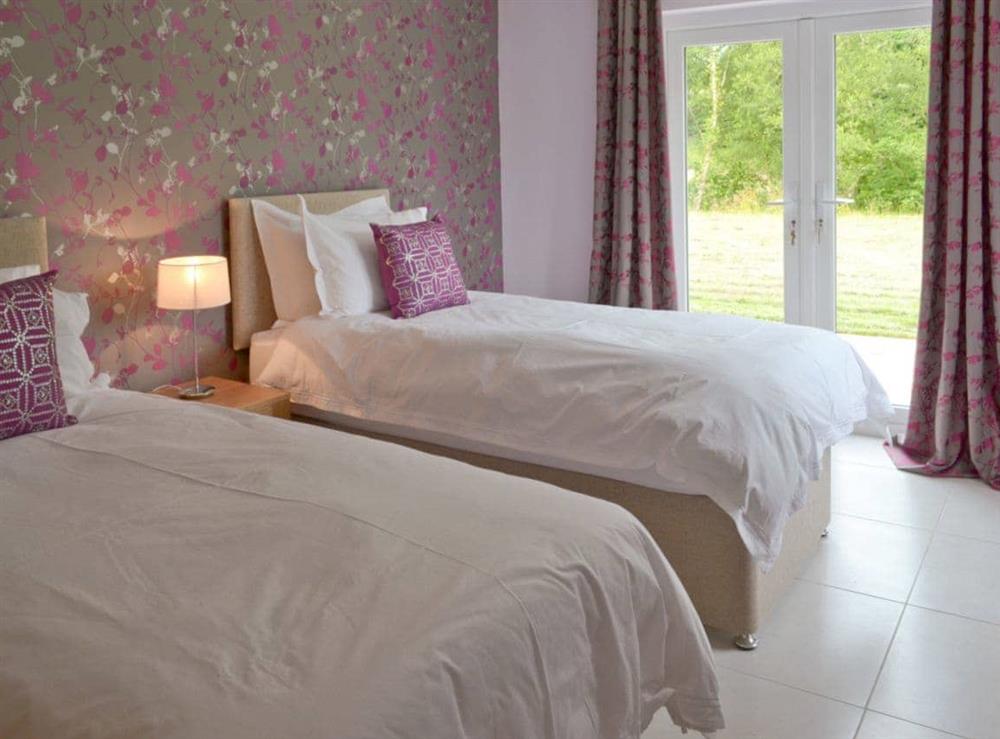 Peaceful twin bedroom with French doors to garden at Sundance, 