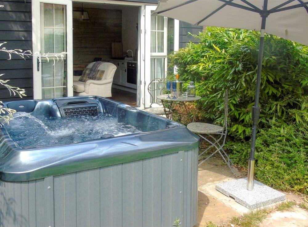 Relaxing hot tub in the garden (photo 2) at Horseshoes House in Saham Toney, Norfolk