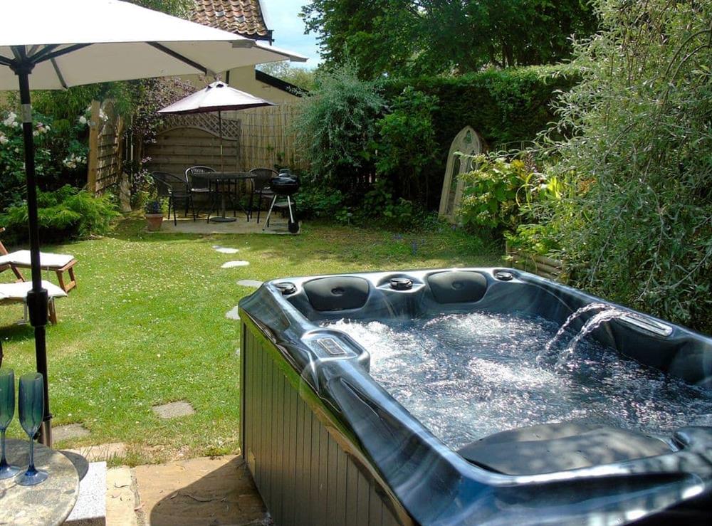 Relaxing hot tub in the garden at Horseshoes House in Saham Toney, Norfolk