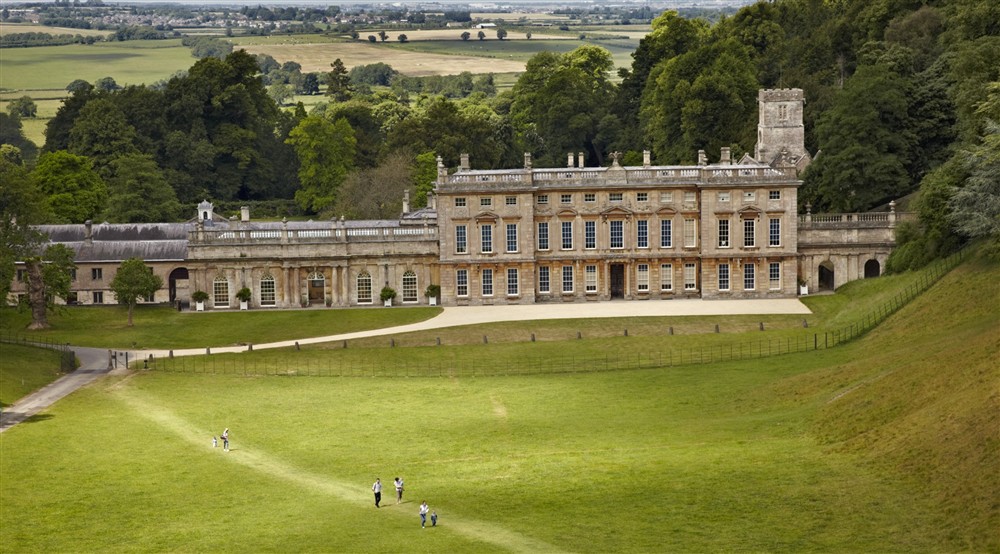 View of the east side of Dyrham Park house with parkland and views behind and people in foreground. Dyrham Park, South Gloucestershire at Horton Court in Nr Chipping Sodbury, Gloucestershire