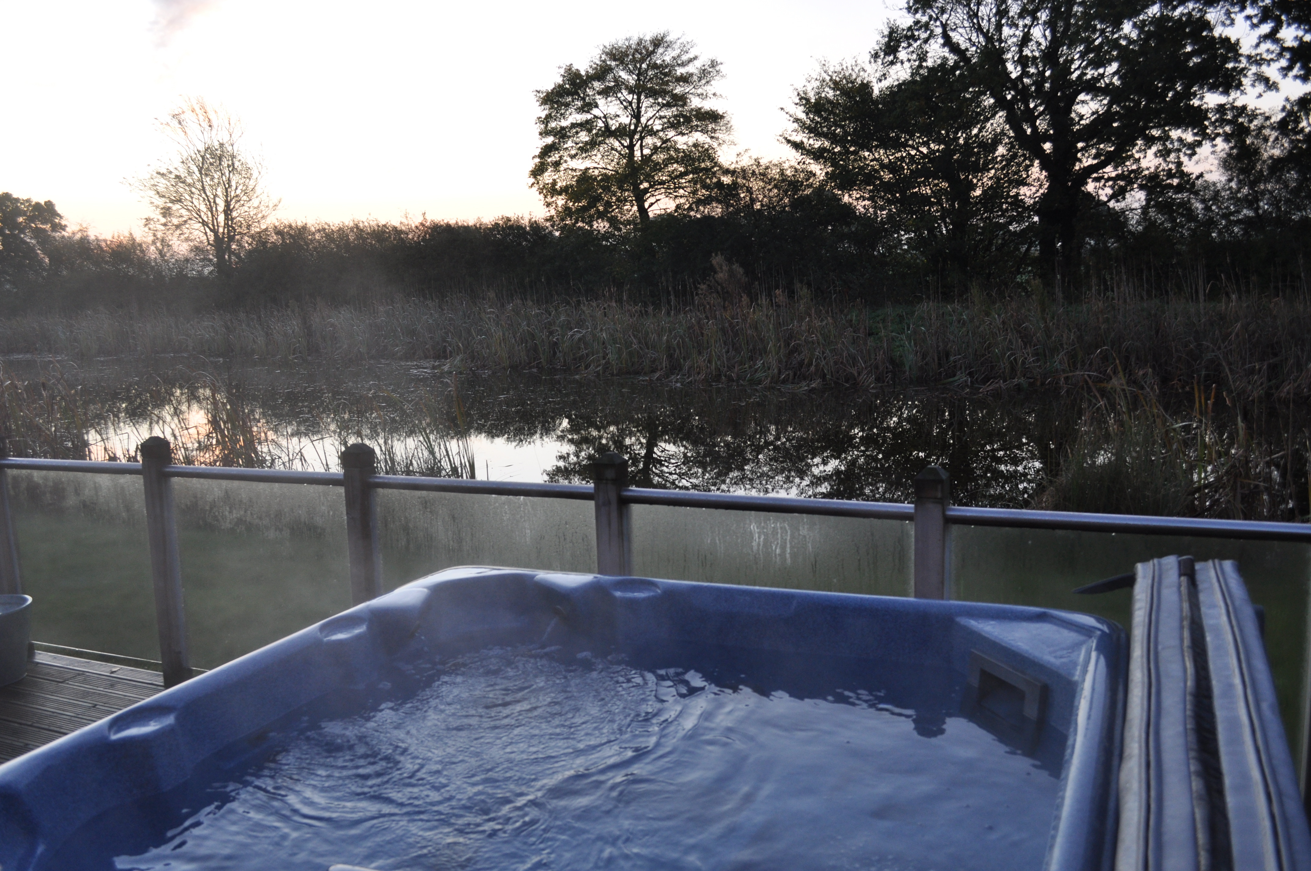 Lay in the hot tub and look out over the lake at Oakwood Lodges