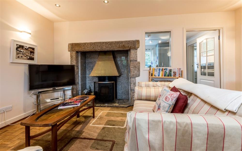 The lounge has a wood burning stove set in a granite fireplace, which is ideal for the colder months at Hove To in Helford Passage