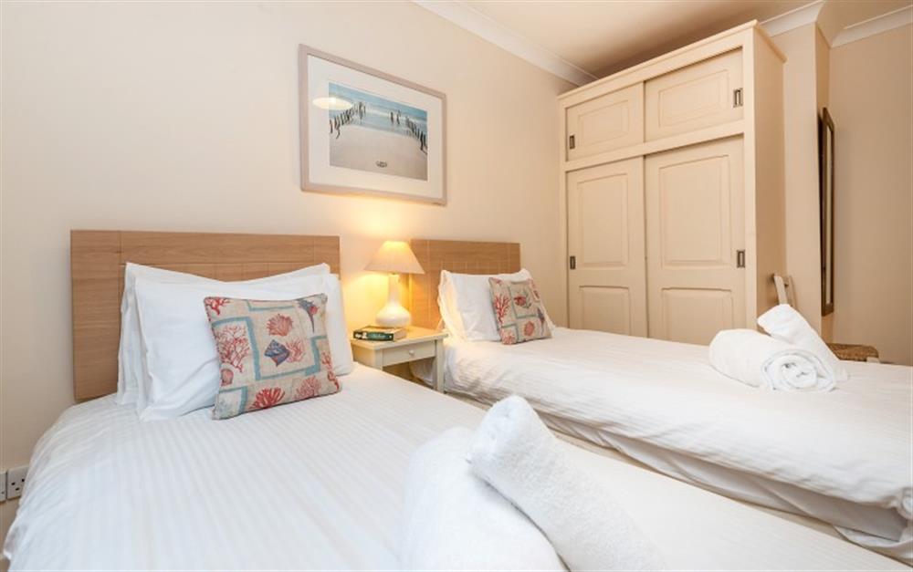 The twin bedroom is painted and carpeted in neutral colours. at Hove To in Helford Passage