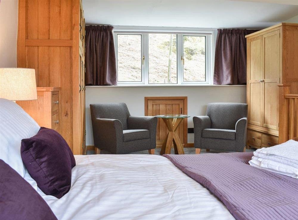 Bedroom with hotel-style seating area at Hovera in Glenridding, near Penrith, Cumbria