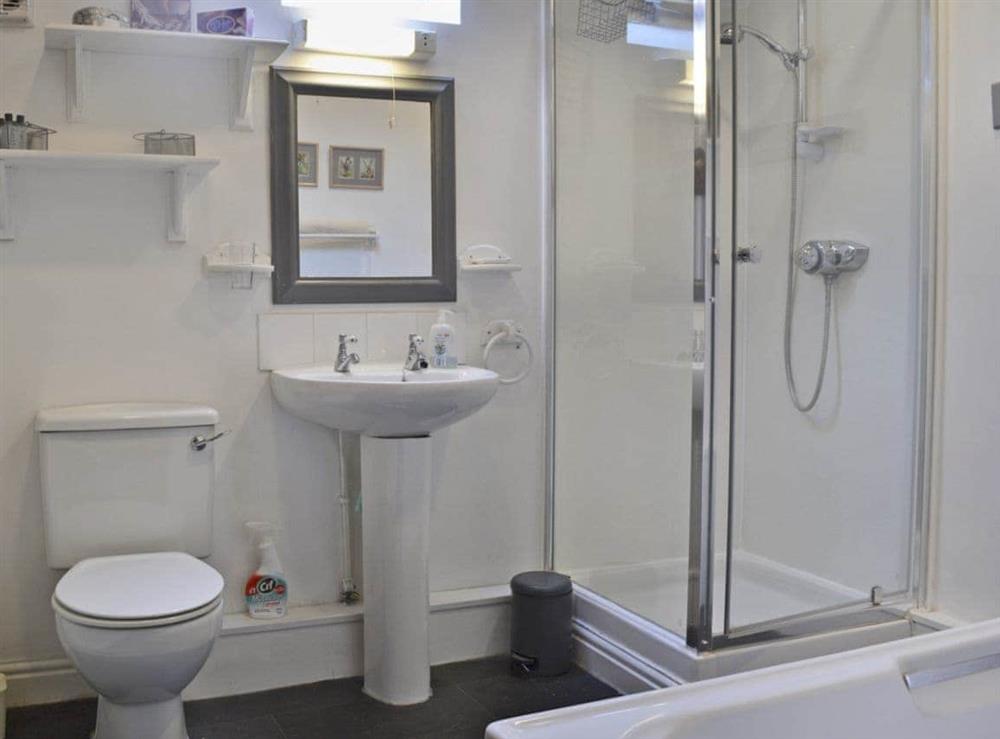 Bathroom with bath and shower cubicle at Howards End in Middleton-on-the-Hill, near Leominster, Herefordshire
