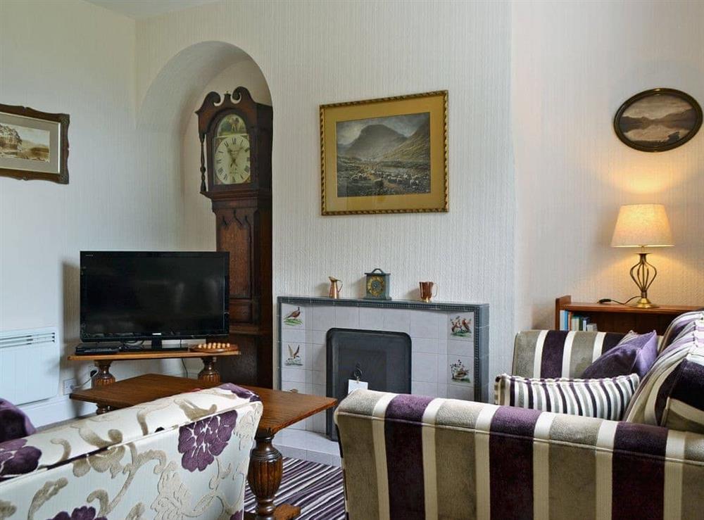 Homely living room with open fire at Howe Bridge House in near Portinscale, Cumbria