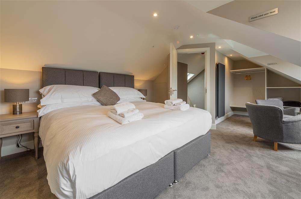 Bedroom five with super-king size zip and link bed and en-suite shower room at Howe Top, Bowness-On-Windermere