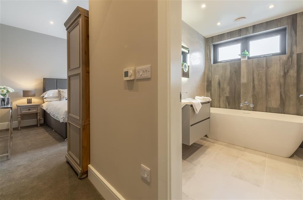 Bedroom one with super-king size zip and link bed with en-suite bathroom at Howe Top, Bowness-On-Windermere