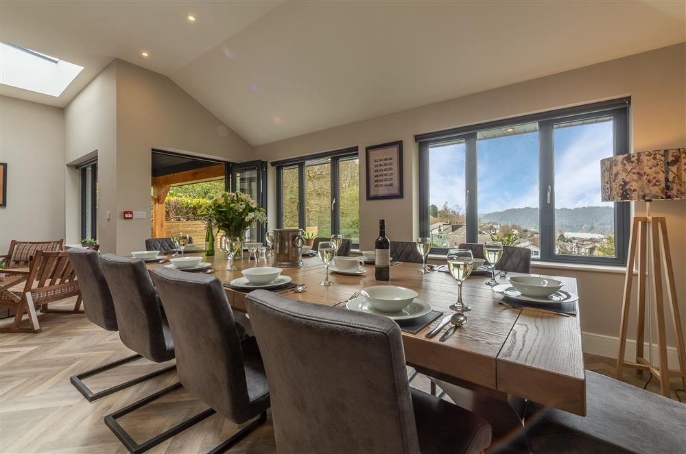 Dining room with table seating for 10 guests and views towards the lake at Howe Top, Bowness-On-Windermere