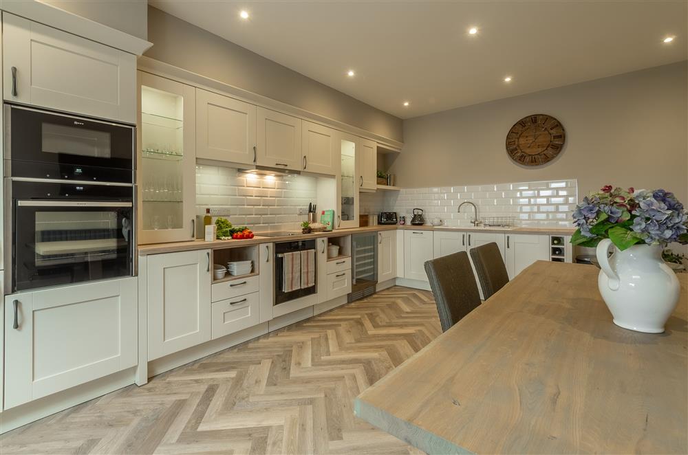 Modern kitchen with high quality appliances and breakfast table at Howe Top, Bowness-On-Windermere