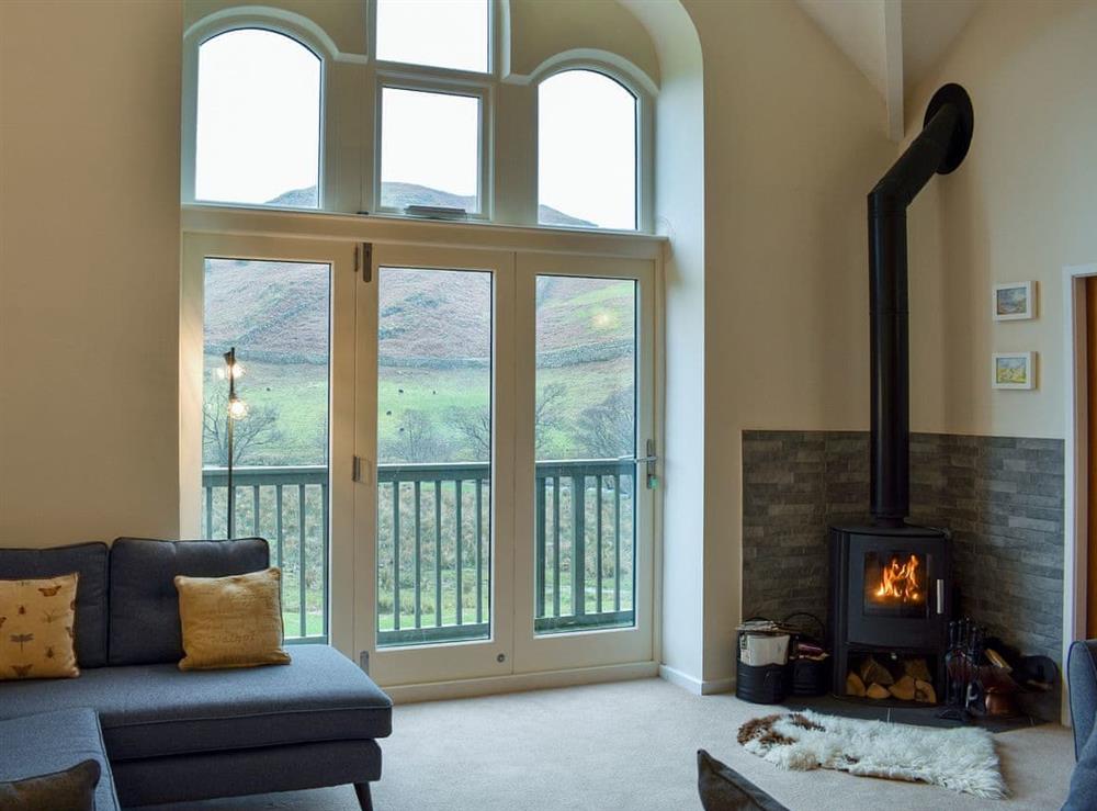 Homely living area with balcony at Howegrain Lodge in Pooley Bridge, near Ullswater, Cumbria