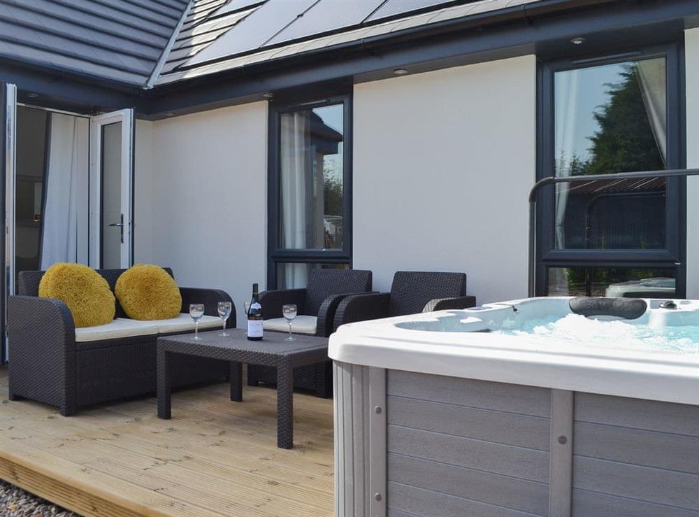 Outdoor area with hot tub at Daisy Cottage, 