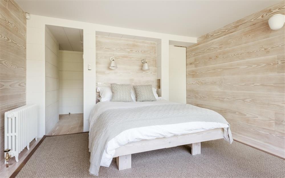 The master bedroom in the modern extension looks over the rear garden at Huccombe Farmhouse in Beesands