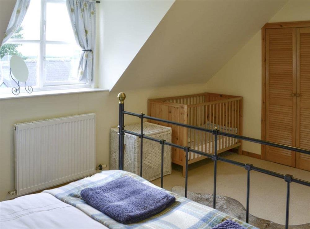 Second double bedroom with cot at Hume Orchard Steading in Hume, near Kelso, Roxburghshire