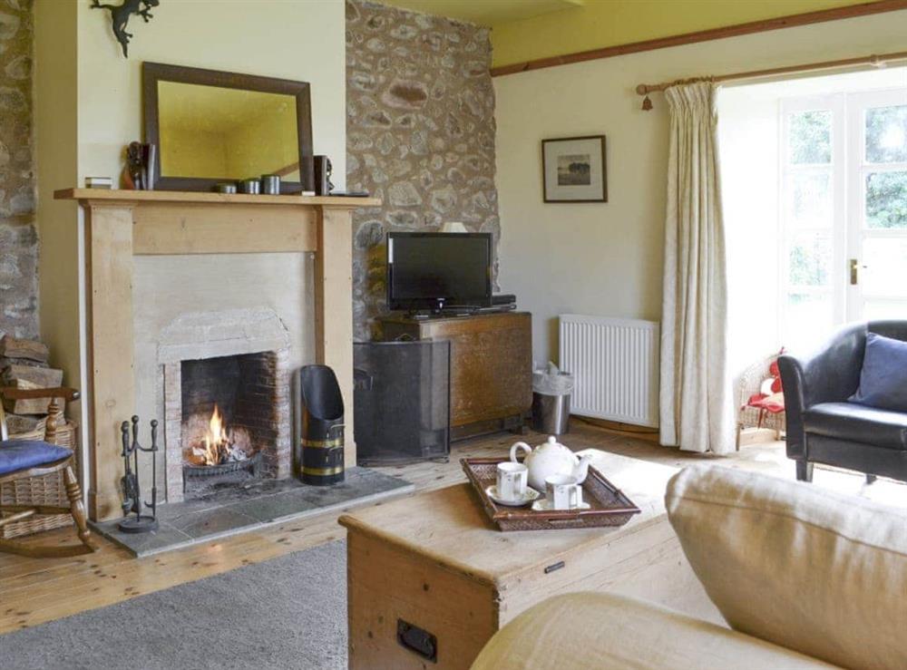 Welcoming living room with French doors to garden at Hume Orchard Steading in Hume, near Kelso, Roxburghshire