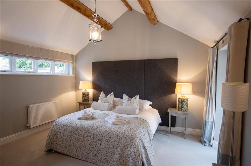 Bedroom with a 6’ super-king size zip and link bed (can be twin singles on request) at Hunter Cottage, Clanfield