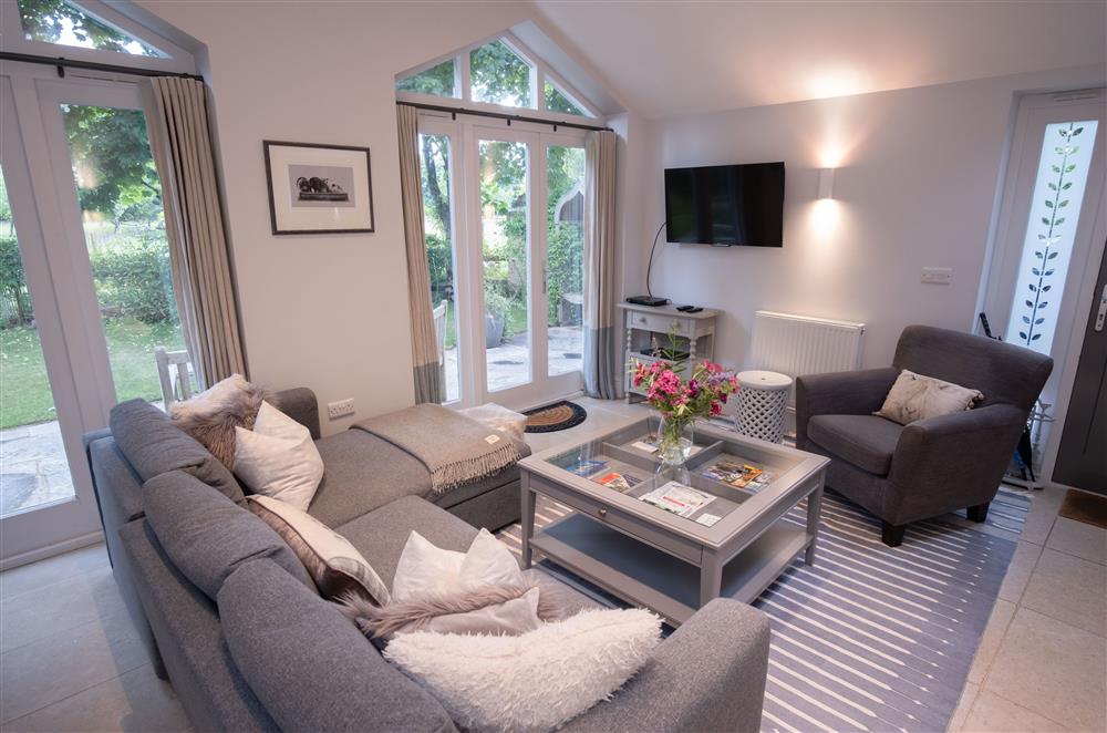 Sitting room with french doors to the garden at Hunter Cottage, Clanfield