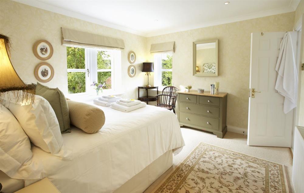 Bedroom with a 4’6 double bed and en-suite shower room at Hunter Court, Clanfield