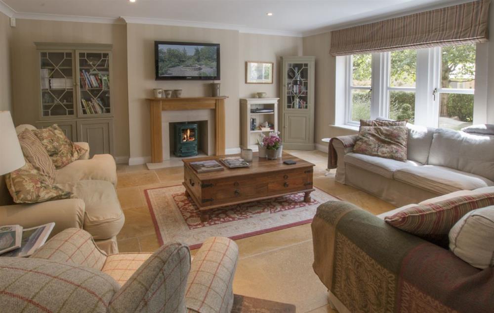 Family room with a wood burning stove at Hunter Court, Clanfield