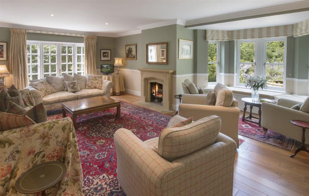 Large sitting room with an open fire at Hunter Court, Clanfield