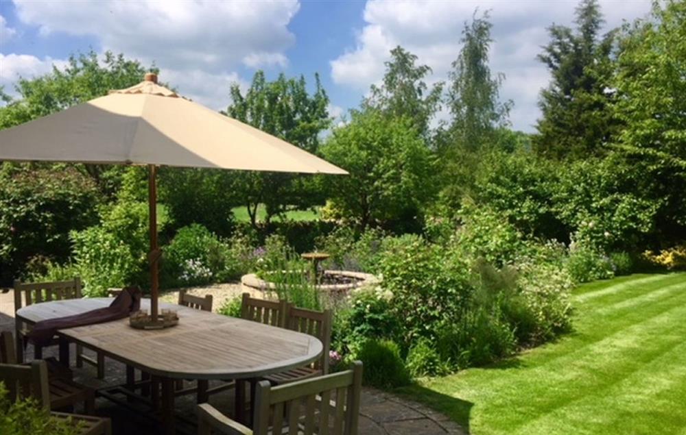 Lovely walled garden with feature pond and trees, overlooking fields at Hunter Court, Clanfield