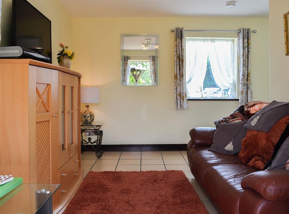 Comfortable living room with tiled floor at Hunters Cottage in Y Ffôr, near Pwllheli, Gwynedd