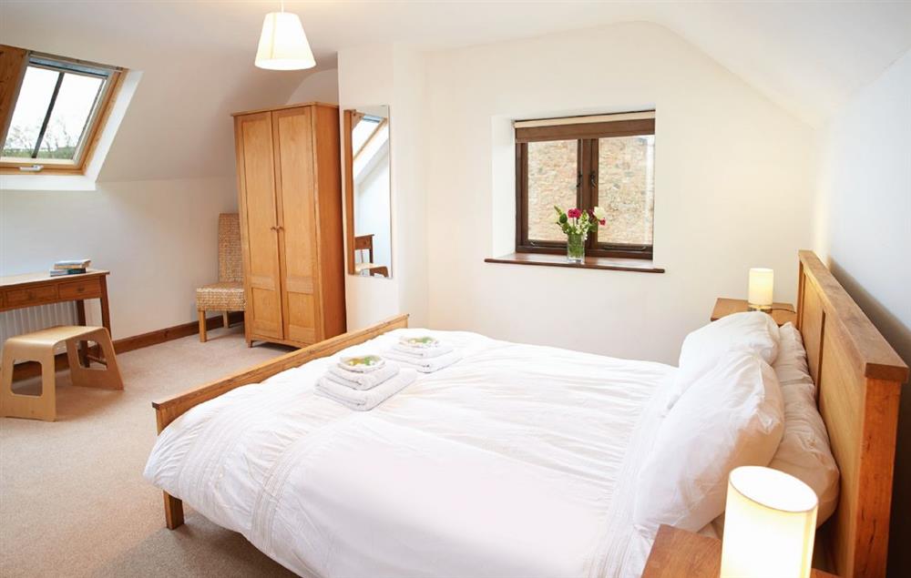 Double bedroom with 5’ bed and en-suite shower room at Hunters Moon, Feniton