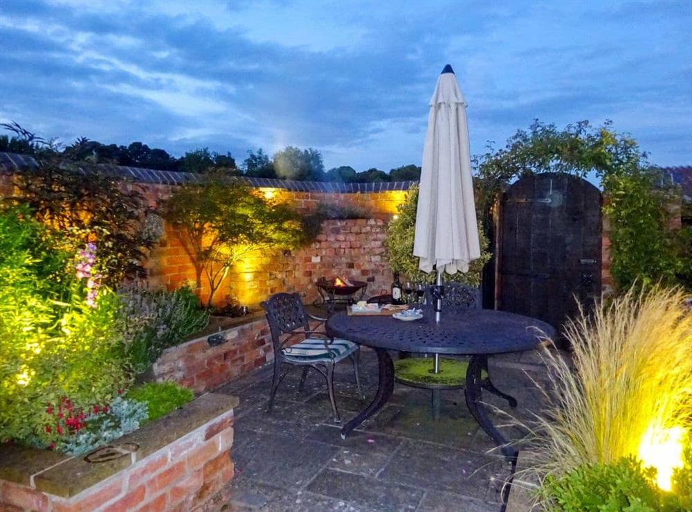 Inviting garden area at night time at Hurdlemakers Loft in Upper Brailes, near Banbury, Warwickshire
