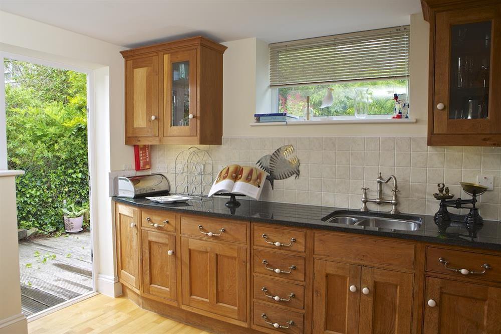 The kitchen leads out to the decked area at the rear of the property at Hydeaway, 7 Grafton Towers in South Sands, Salcombe