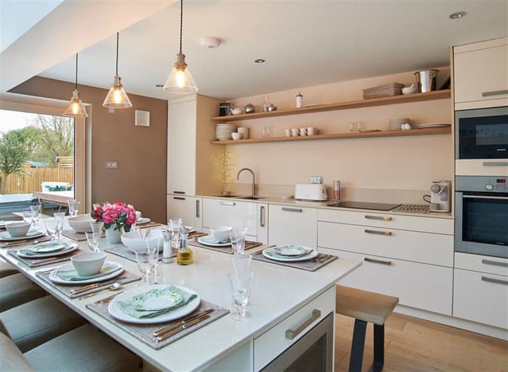 Luxurious kitchen with dining island at Hydrangea House in Hythe, England