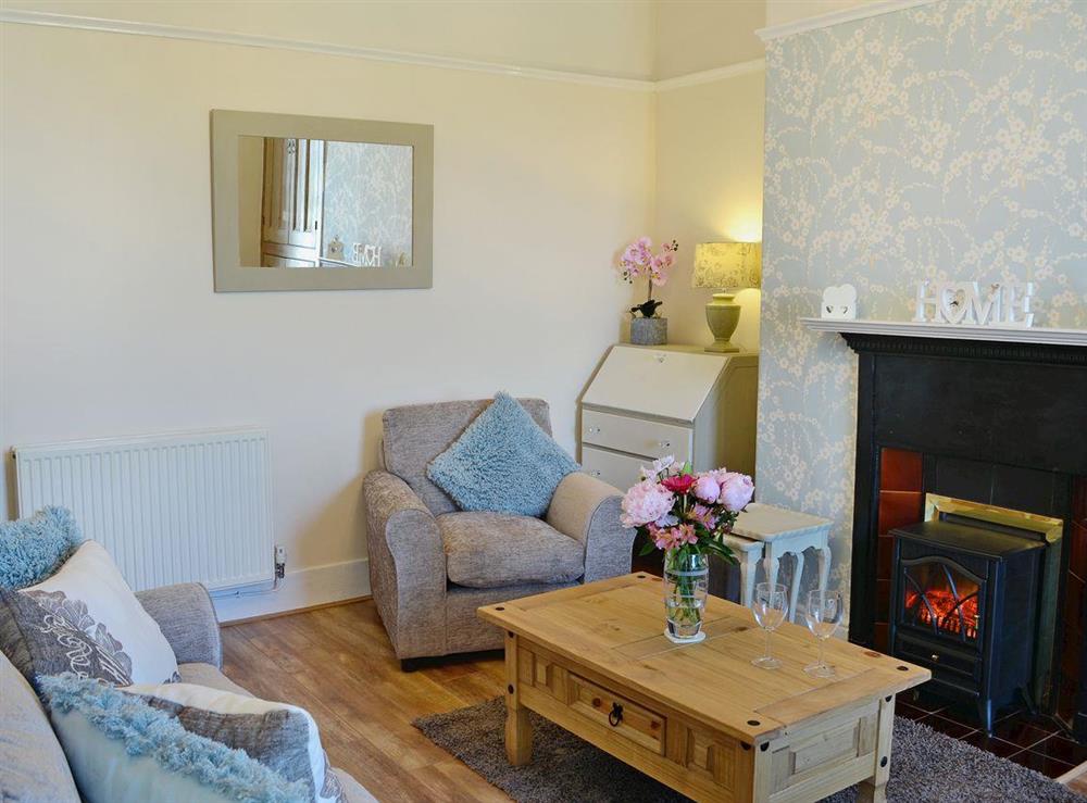 Homely living room with cosy gas woodburner at Hyfrydle in Llandudno, Gwynedd