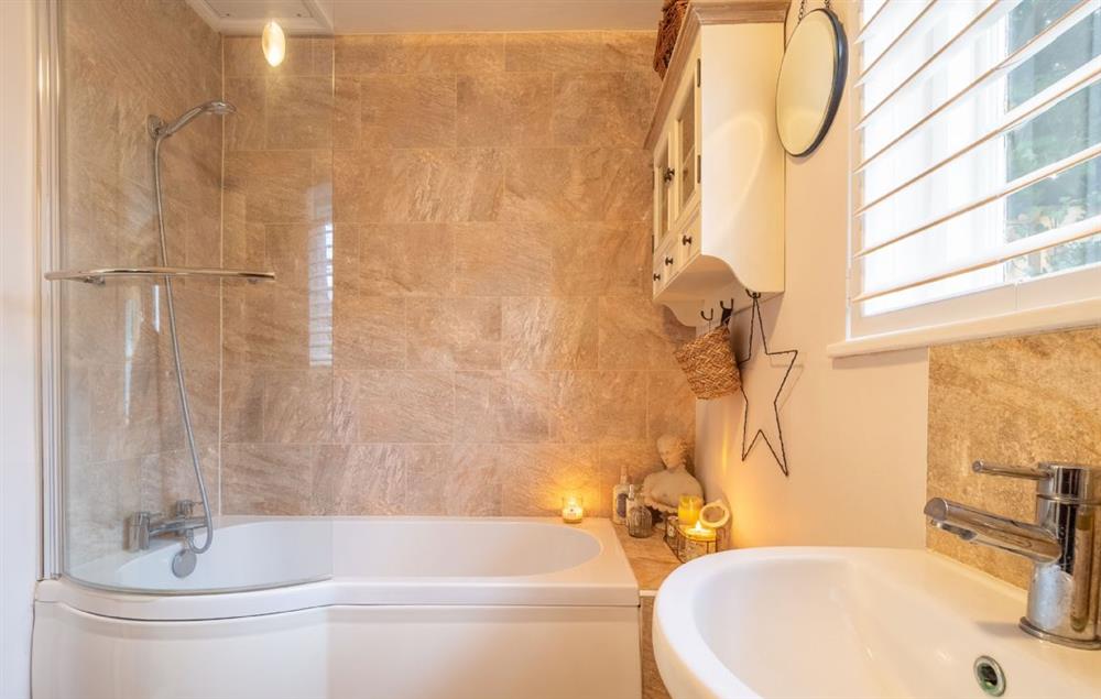 Bathroom with shower over the bath at Hylton Cottage, Lavenham