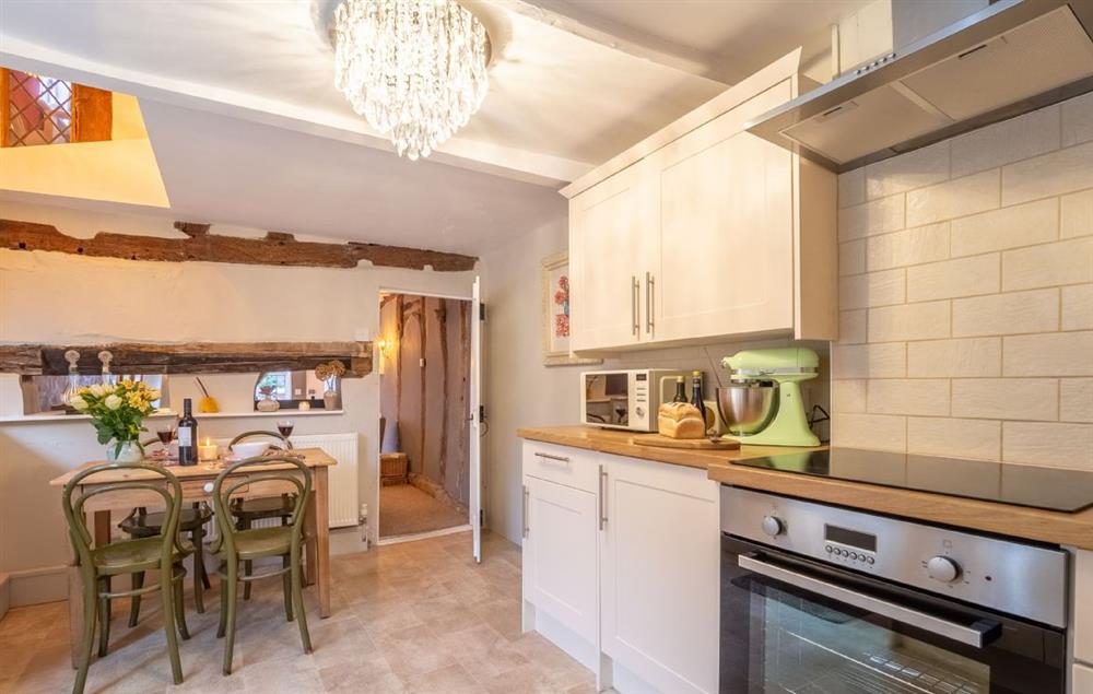 Bespoke and fully equipped kitchen with door to rear courtyard at Hylton Cottage, Lavenham