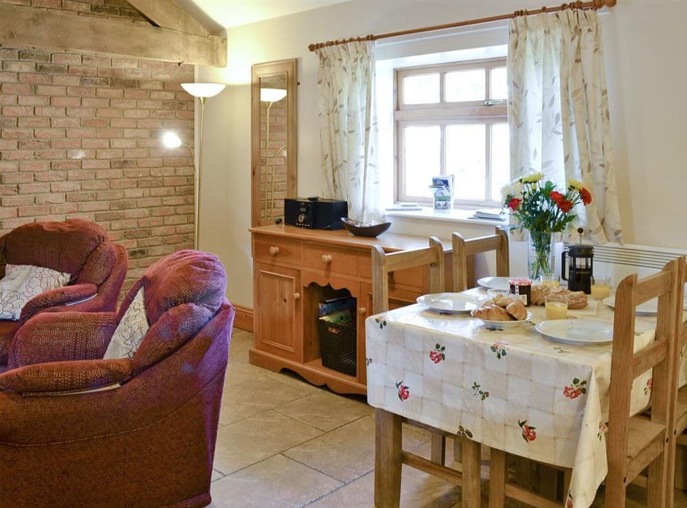 Intimate dining area in open-plan room at Ilingworth Cottage in Muston, Filey, North Yorkshire