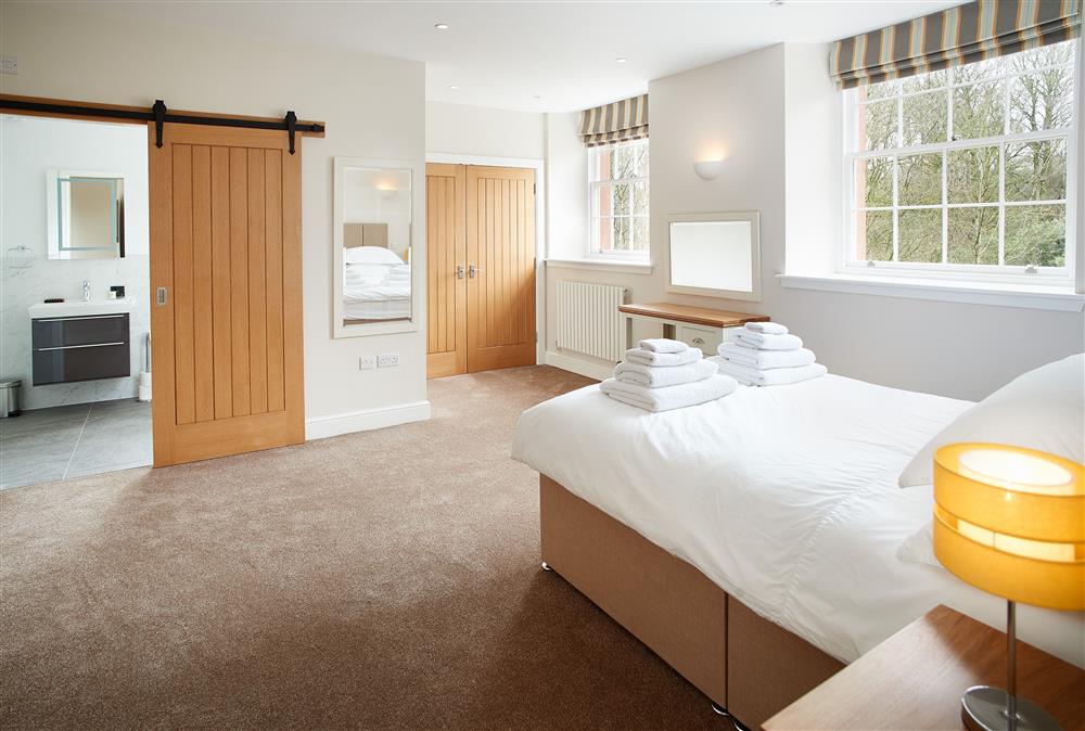 Bedroom with 4’6 double bed and en-suite wet room (photo 2) at Independent Apartment, Netherby Hall, Longtown