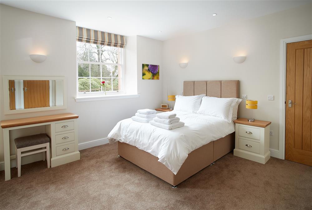 Bedroom with 4’6 double bed and en-suite wet room at Independent Apartment, Netherby Hall, Longtown