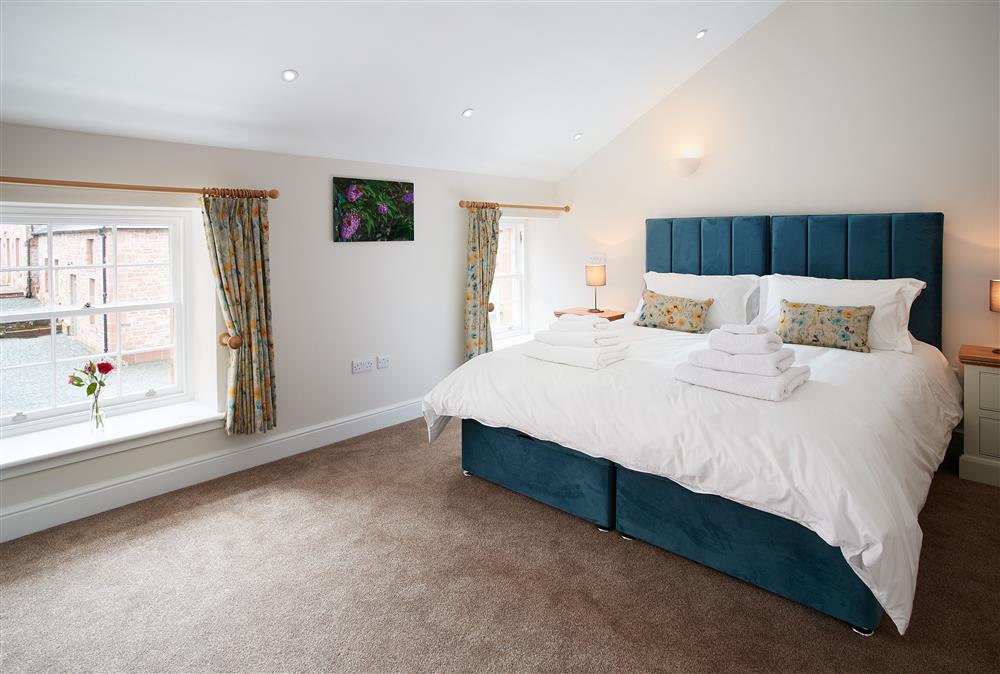 Bedroom with a 5’ king-size zip and link bed and en-suite wet room at Independent Apartment, Netherby Hall, Longtown