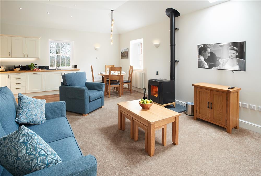 Contemporary living area with sitting room, dining area and well-equipped kitchen at Independent Apartment, Netherby Hall, Longtown