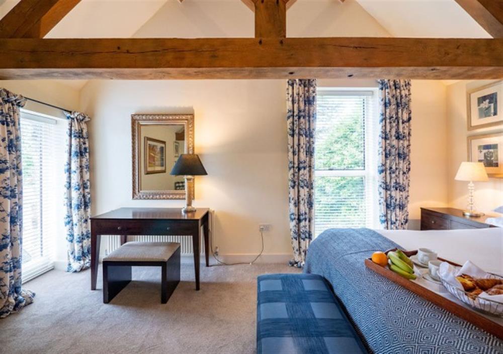 Bedroom 1 with large windows and views out to surrounding woodland and grounds at Ingle Tor in Chagford