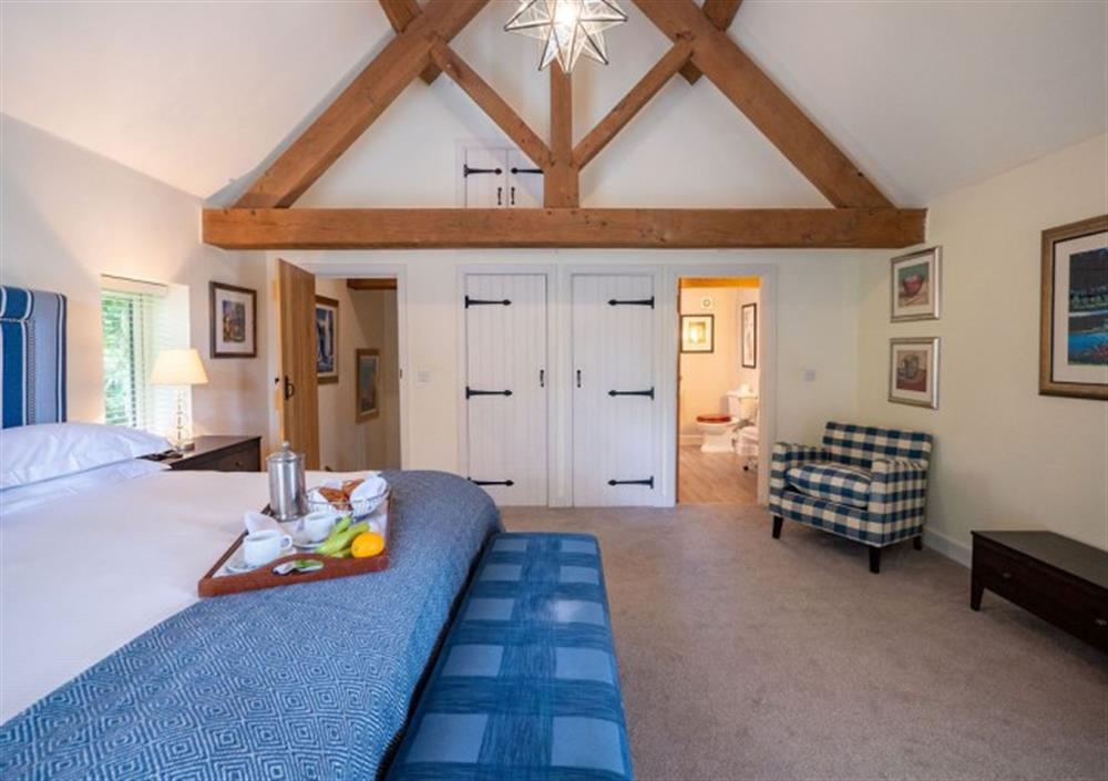 Top floor Bedroom 1 with high ceilings and built-in wardrobe at Ingle Tor in Chagford