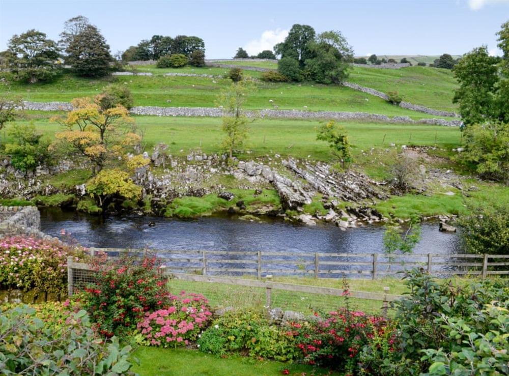 Expansive views from the rear over the River Wharfe. at Inglenook Cottage in Linton Falls, near Grassington, North Yorkshire