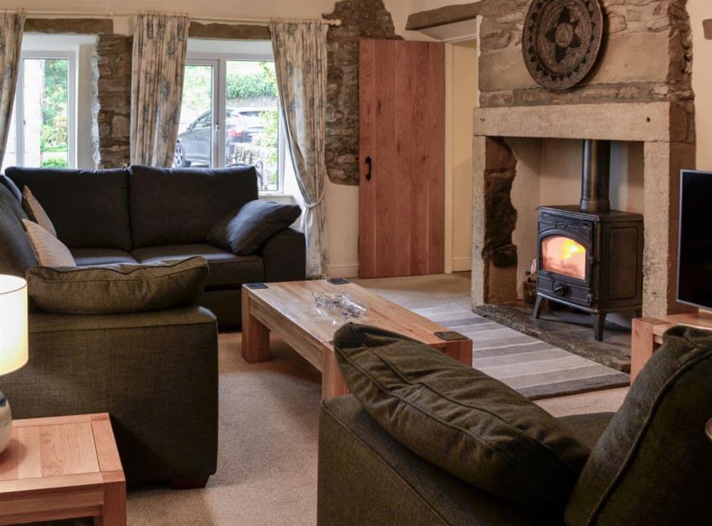 Thoughtfully furnished living room with Inglenook fireplace at Inglenook Cottage in Linton Falls, near Grassington, North Yorkshire