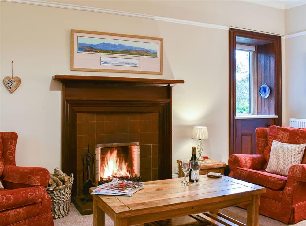 Cosy living room with open fireplace at Ingleside in Whiting Bay, Isle of Arran, Scotland
